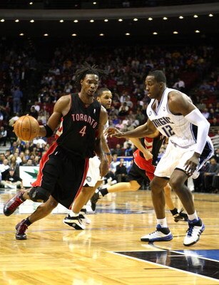 ORLANDO, FL - NOVEMBER 18: Chris Bosh #4 of the Toronto Raptors drives against Dwight Howard #12 of the Orlando Magic during the game on November 18, 2008 at Amway Arena in Orlando, Florida.  NOTE TO USER: User expressly acknowledges and agrees that, by d