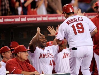ANAHEIM, CA - APRIL 22:  Kendry Morales #19 of the Los Angeles Angels of Anaheim is congratulated by teammate Torii Hunter #48 after hitting a three-run home run against the Detroit Tigers during the first inning of the baseball game at Angel Stadium on A