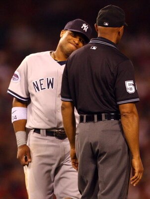 ANAHEIM, CA - SEPTEMBER 09:  Second baseman Robinson Cano #24 of the New York Yankees reacts to a call by second base umpire CB Bucknor in which Robb Quinlan of the Los Angeles Angels of Anaheim was called safe after stealing second base in the fifth inni