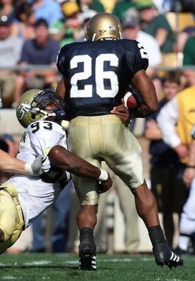SOUTH BEND, IN - SEPTEMBER 01: Travis Thomas #26 of the Notre Dame Fighting Irish is tackled for a loss by Michael Johnson #93 of the Georgia Tech Yellow Jackets on September 1, 2007 at Notre Dame Stadium in South Bend, Indiana. (Photo by Jonathan Daniel/