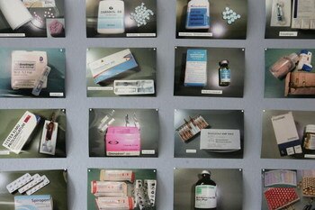 BERLIN - AUGUST 29:  Photos of anabolic steroids confiscated in a police bust earlier in the day stand on display at police headquarters August 29, 2006 in Berlin, Germany. Police in the German states of Berlin, Lower Saxony and Brandenburg as well as in 