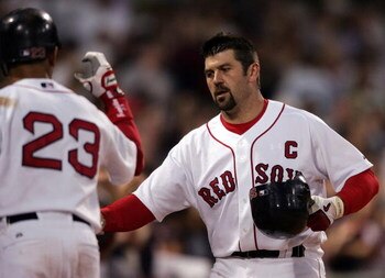 BOSTON - MAY 29:  Jason Varitek #33 of the Boston Red Sox is congratulated by teammate Julio Lugo #23 after Varitek hit a solo home run in the fifth inning against the Cleveland Indians at Fenway Park May 29, 2007 in Boston, Massachusetts.  (Photo by Elsa