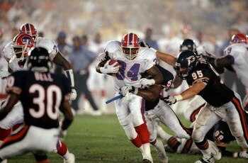 21 Aug 1998:  Running back Thurman Thomas #34 of the Buffalo Bills in action against linebacker Andre Collins #52 and defensive end Mark Thomas #95 of the Chicago Bears during the pre-season game at Soldier Field in Chicago, Illinois. The Bills defeated t