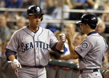 KANSAS CITY, MO - AUGUST 17:  Bret Boone #29 of the Seattle Mariners gets congratulated by the Mariner's batboy after he hit a solo homer against the Kansas City Royals on August 17, 2004 at Kauffman Stadium in Kansas City, Missouri.  (Photo by Dave Kaup/