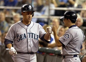 KANSAS CITY, MO - AUGUST 17:  Bret Boone #29 of the Seattle Mariners gets congratulated by the Mariner's batboy after he hit a solo homer against the Kansas City Royals on August 17, 2004 at Kauffman Stadium in Kansas City, Missouri.  (Photo by Dave Kaup/