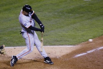 ANAHEIM, CA - OCTOBER 26:   Jeff Kent #21 of the San Francisco Giants hits an rbi single to score teammate Kenny Lofton #1 in the seventh inning of game six of the World Series on October 26, 2002 at Edison Field in Anaheim, California. (Photo by Donald M