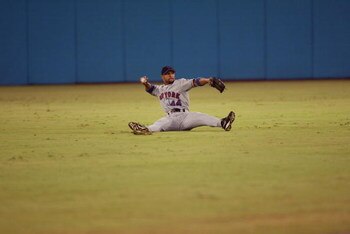 MIAMI - JULY 7:  Outfielder Jay Payton #44 of the New York Mets attempts to make a throw against the Florida Marlins during the game on July 7, 2002 at Pro Player Stadium in Miami, Florida.  The Mets won 9-3.  (Photo By Eliot J. Schechter/Getty Images)