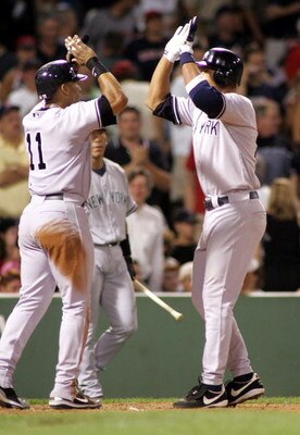 BOSTON - JULY 14:  Alex Rodriguez #13 of the New York Yankees high-fives teammate Gary Sheffield #11 at home after both scored on a two-run home run by Rodriguez in the ninth inning against the Boston Red Sox at Fenway Park on July 14, 2005 in Boston, Mas