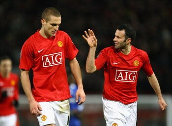 MANCHESTER, UNITED KINGDOM - JANUARY 11:  Nemanja Vidic of Manchester United is congratulated by team mate Ryan Giggs (R) after scoring the opening goal during the Barclays Premier League match between Manchester United and Chelsea at Old Trafford on Janu