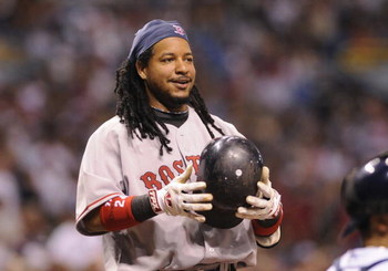 ST PETERSBURG, FL - July 2: Designated hitter Manny Ramirez #24 of the Boston Red Sox smiles after ducking from an inside pitch  against the Tampa Bay Rays July 2, 2008 at Tropicana Field in St. Petersburg, Florida.  (Photo by Al Messerschmidt/Getty Image