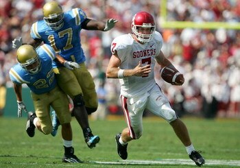 PASADENA, CA - SEPTEMBER 17:  Rhett Bomar #7 of the Oklahoma Sooners is chased down by Michael Norris #22 and Justin Hickman #17 of the UCLA Bruins during their game on September 17, 2005 at the Rose Bowl in Pasadena, California.  (Photo by Jeff Gross/Get