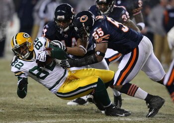 CHICAGO - DECEMBER 22: Lance Briggs #55 and Kevin Payne #44 of the Chicago Bears bring down Ruvell Martin #82 of the Green Bay Packers on December 22, 2008 at Soldier Field in Chicago, Illinois. (Photo by Jonathan Daniel/Getty Images)