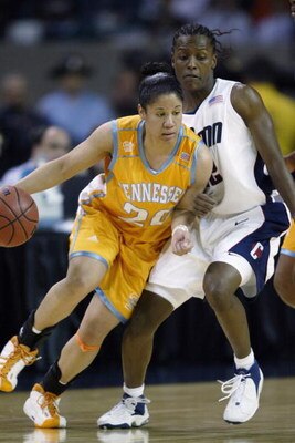 ATLANTA - APRIL 8:  Kara Lawson #20 of the University of Tennessee Lady Volunteers drives around Ashley Battle #22 of Connecticut Huskies during the NCAA Women's Championship game at the Georgia Dome on April 8, 2003 in Atlanta, Georgia. Connecticut beat 
