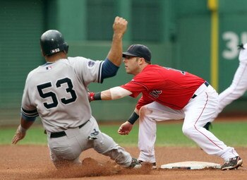 BOSTON - SEPTEMBER 28: Dustin Pedroia #15 of the Boston Red Sox is unable to tag out Bobby Abreu #53  of the New York Yankees on September 28, 2008 during game one of the double header at Fenway Park in Boston, Massachusetts.  (Photo by Elsa/Getty Images)