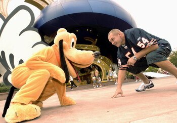 LAKE BUENA VISTA, FL - OCTOBER 11: In this handout photo Chicago Bears linebacker Brian Urlacher takes time out to line up with Pluto October 11, 2005 at the Disney-MGM Studios in Lake Buena Vista, Florida.  Urlacher was at Walt Disney World today to tape