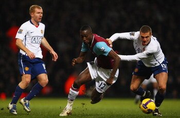 LONDON - FEBRUARY 08:  Nemanja Vidic of Manchester United challenges Carlton Cole of West Ham United during the Barclays Premier League match between West Ham United and Manchester United at Upton Park on February 8, 2009 in London, England.  (Photo by Ry