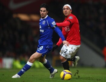 MANCHESTER, UNITED KINGDOM - JANUARY 31:  Carlos Tevez of Manchester United competes for the ball with Mikel Arteta of Everton during the Barclays Premier League match between Manchester United and Everton at Old Trafford on January 31, 2009 in Manchester