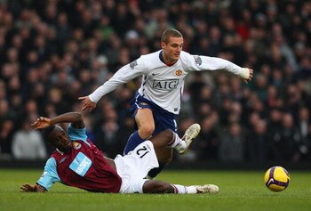 LONDON - FEBRUARY 08:  Nemanja Vidic of Manchester United challenges Carlton Cole of West Ham United  during the Barclays Premier League match between West Ham United and Manchester United at Upton Park on February 8, 2009 in London, England.  (Photo by R