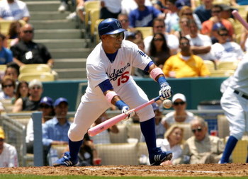 LOS ANGELES - MAY 13: Rafael Furcal #15 of the Los Angeles Dodgers lays down a sacrifice bunt to bring in a run in the second inning against the Cincinnati Reds at Dodger Stadium May 13, 2007 in Los Angeles, California. The Dodgers won 10-5. (Photo by S