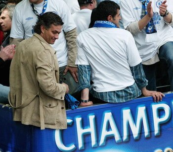 LONDON - MAY 22:  Chelsea manager Jose Mourinho smiles at fans as players display the FA Barclays Premier League trophy and League Cup on team bus as they make their way down New King's Road on the Chelsea Football Club victory parade on May 22, 2005 in L