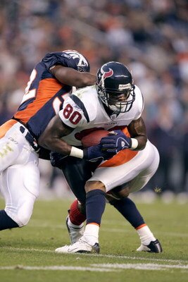 DENVER - AUGUST 27:  Wide receiver Andre Johnson #80 of the Houston Texans is tackled by the Denver Broncos during a preseason game on August 27, 2006 at Invesco Field at Mile High in Denver, Colorado.  The Broncos won 17-14.  (Photo by Brian Bahr/Getty I
