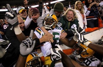 DENVER - OCTOBER 29:  Greg Jennings #85 of the Green Bay Packers is hoisted into the stands by his teammates after catching an 82-yard game-winning touchdown pass from Brett Favre in Monday Night Football against the Denver Broncos at Invesco Field at Mil