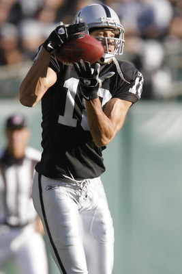 OAKLAND, CA - AUGUST 23: Wide receiver Drew Carter #18 of the Oakland Raiders catches a pass against the Arizona Cardinals on August 23, 2008 at the McAfee Coliseum in Oakland, California. (Photo by Greg Trott/Getty Images)