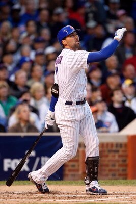 CHICAGO - OCTOBER 01:  Mark DeRosa #7 of the Chicago Cubs hits a 2-run home run in the bottom of the second inning against the Los Angeles Dodgers in Game One of the NLDS during the 2008 MLB Playoffs at Wrigley Field on October 1, 2008 in Chicago, Illinoi