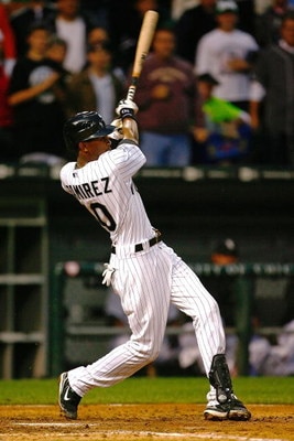 CHICAGO - SEPTEMBER 29:  Alexei Ramirez #10 of the Chicago White Sox hits a grand slam home run to give the White Sox a 6-2 lead in the bottom of the sixth inning against the Detroit Tigers at U.S. Cellular Field on September 29, 2008 in Chicago, Illinois