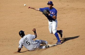 ARLINGTON, TX - JULY 13:  Second baseman Ian Kinsler #5 of the Texas Rangers makes the out against Juan Uribe #5 of the Chicago White Sox in the 7th inning on July 13, 2008 at Rangers Ballpark in Arlington, Texas.  (Photo by Ronald Martinez/Getty Images)