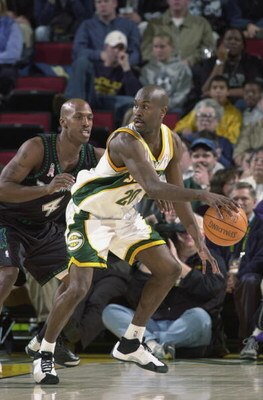SEATTLE - NOVEMBER 27:  Point guard Gary Payton #20 of the Seattle SuperSonics posts up guard Chauncey Billups #4 of the Minnesota Timberwolves during the NBA game at Key Arena in Seattle, Washington on November 27, 2001.  The Sonics won 112-102.  NOTE TO