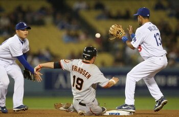 LOS ANGELES, CA - SEPTEMBER 28:   Kevin Frandsen #19 of the San Francisco Giants is forced out at second base in the 8th inning against (L-R) Chin-Lung Hu #60 and Wilson Valdez #13 of the Los Angeles Dodgers at Dodger Stadium on September 28, 2007 in Los 
