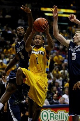 MILWAUKEE - JANUARY 31: Dominic James #1 of the Marquette Golden Eagles goes up for a shot against DaJuan Summers #3 and Nikita Mescheriakov #5 of the Georgetown Hoyas on January 31, 2009 at the Bradley Center in Milwaukee, Wisconsin. Marquette defeated G