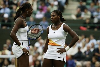 LONDON - JULY 1:  Venus Williams of the USA discusses tactics with sister Serena during the third round match of the Ladies' Doubles at the Wimbledon Lawn Tennis Championships held on July 1, 2003 at the All England Lawn Tennis and Croquet Club, in Wimble