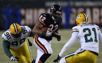 CHICAGO - DECEMBER 22: Matt Forte #22 of the Chicago Bears runs for yardage against Alfred Malone #98 and Charles Woodson #21 of the Green Bay Packers on December 22, 2008 at Soldier Field in Chicago, Illinois. The Bears defeated the Packers 20-17 in over