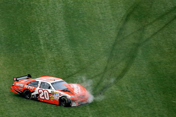 DAYTONA BEACH, FL - FEBRUARY 15: Joey Logano, driver of the #20 Home Depot Toyota, crashes during the NASCAR Sprint Cup Series Daytona 500 at Daytona International Speedway on February 15, 2009 in Daytona Beach, Florida.  (Photo by Matthew Stockman/Getty 
