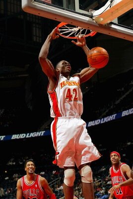 ATLANTA - JANUARY 21:  Theo Ratliff #42 of the Atlanta Hawks dunks as Scottie Pippen #33 and Jerome Williams #11 of the Chicago Bulls look on January 21, 2004  at Philips Arena in Atlanta, Georgia.  (Photo by Jamie Squire/Getty Images)