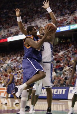 GREENSBORO, NC - MARCH 12:  Elton Brown #43 of the Virginia Cavaliers looks to shoot over Shelden Williams #23 of the Duke Blue Devils during their ACC Quarterfinal game on March 12, 2004 at the Greensboro Coliseum in Greensboro, North Carolina. The Blue 