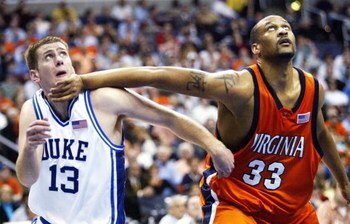 WASHINGTON - MARCH 11:  Lee Melchionni #13 of the Duke Blue Devils gets a hand to the chin from Devin Smith #33 of the Virginia Cavaliers during their second round ACC Tournament game at the MCI Center on March 11, 2005 in Washington, DC.  (Photo by Doug 