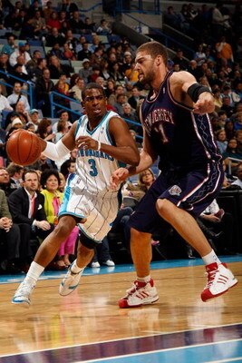 NEW ORLEANS - JANUARY 21:  Chris Paul #3 of the New Orleans Hornets drives around Brook Lopez #11 of the New Jersey Nets on January 21, 2009 at the New Orleans Arena in New Orleans, Louisiana.  NOTE TO USER: User expressly acknowledges and agrees that, by
