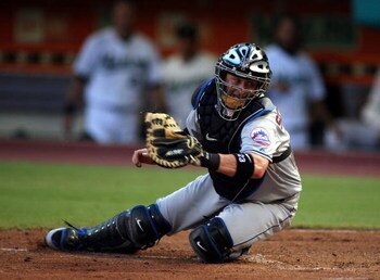 MIAMI - JULY 30:  Catcher Brian Schneider #23 of the New York Mets looks to tag a runner at home plate against the Florida Marlins in the third inning on July 30, 2008 at Dolphin Stadium in Miami, Florida.  The Marlins defeated the Mets 7-4.  (Photo by Ma