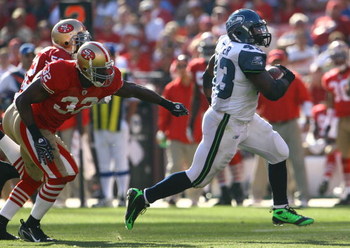 SAN FRANCISCO - OCTOBER 26: Fullback Leonard Weaver #43 of the Seattle Seahawks outruns Michael Lewis #32 of the San Francisco 49ers for a touchdown in the third quarter at Candlestick Park on October 26, 2008 in San Francisco, California. The Seahawks d