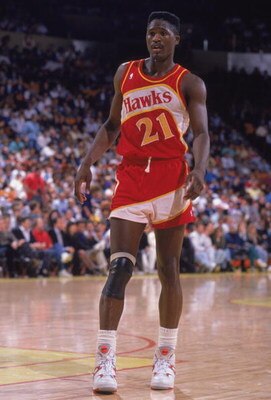 INGLEWOOD, CA - 1989:  Dominique Wilkins #21 of the Atlanta Hawks stands on the court during a NBA game against the Los Angeles Lakers at the Great Western Forum in Inglewood, California in 1989.  (Photo by Ken Levine/Getty Images)