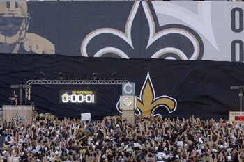 The crowd goes wild as the banner drops outside the Louisana Superdome before the Monday Night Football game between the New Orleans Saints and Atlanta Falcons on September 25, 2006 in New Orleans, Louisiana.  (Photo by Al Messerschmidt/Getty Images)