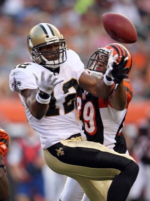CINCINNATI - AUGUST 23:  Marques Colston #12 of the New Orleans Saints and Leon Hall #39 of the Cincinnati Bengals abattle for the ball during the NFL game at Paul Brown Stadium on August 23, 2008 in Cincinnati, Ohio.  (Photo by Andy Lyons/Getty Images)