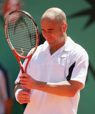 PARIS - MAY 24:  A dejected Andre Agassi of the USA after losing his first round match against Jerome Haehnel of France during Day One of the 2004 French Open Tennis Championship at Roland Garros on May 24, 2004 in Paris, France. (Photo by Clive Mason/Get