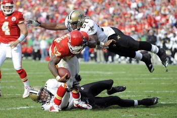 KANSAS CITY, MO - NOVEMBER 16:  Larry Johnson #27 of the Kansas City Chiefs is stopped by Scott Fujita #55 and Jonathan Vilma #51 of the New Orleans Saints on November 16, 2008 at Arrowhead Stadium in Kansas City, Missouri.  (Photo by G. Newman Lowrance/G