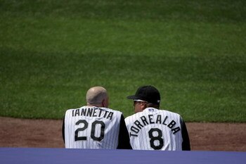 DENVER - MAY 18:  Catchers Chris Ianetta #20 and Yorvit Torreabla #8 of the Colorado Rockies watch the action from the duggout against the Minnesota Twins during Interleague MLB action at Coors Field on May 18, 2008 in Denver, Colorado. The Rockies defeat