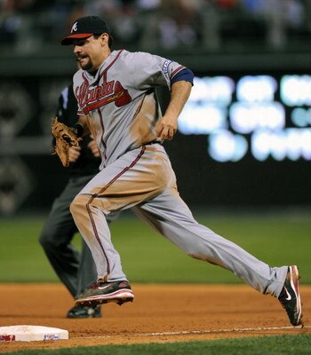 PHILADELPHIA - SEPTEMBER 24: Casey Kotchman #22 of the Atlanta Braves charges first base to get out Chase Utley #26 of the Philadelphia Phillies on September 24, 2008 at Citizens Bank Park in Philadelphia, Pennsylvania. (Photo by Drew Hallowell/Getty Imag