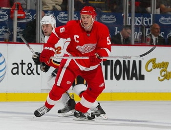 DETROIT-OCTOBER 10:  Niklas Lidstrom #5 of the Detroit Red Wings defends against Daymond Langkow #22 of the Calgary Flames in a game on October 10, 2007 at the Joe Louis Arena in Detroit, Michigan. The Red Wings defeated the Flames 4-2. (Photo by Claus An